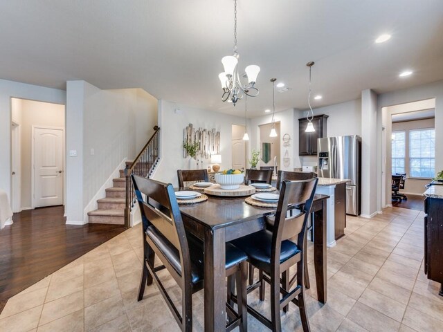 tiled dining area with a chandelier