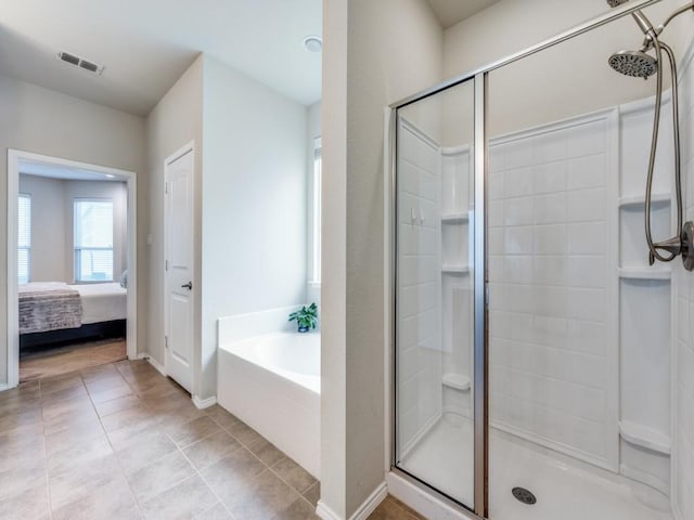 bathroom with tile patterned flooring and shower with separate bathtub