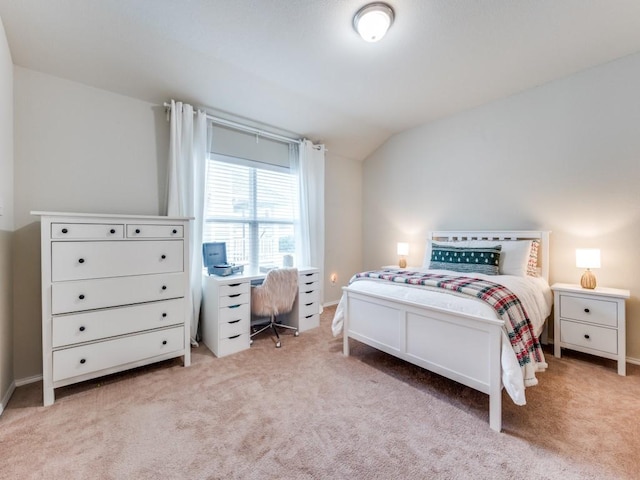 bedroom with light carpet and vaulted ceiling