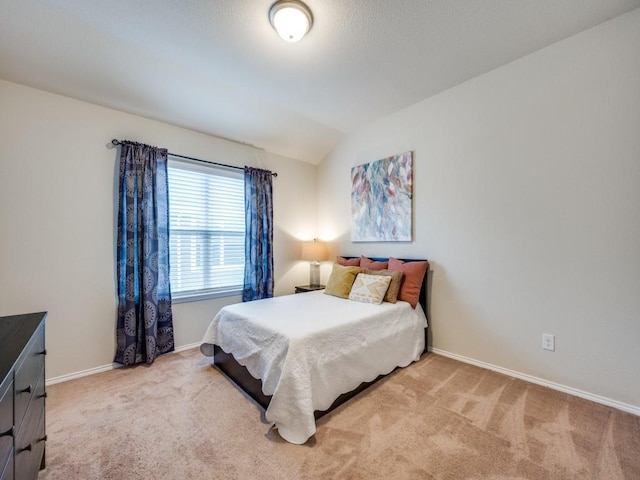 carpeted bedroom with vaulted ceiling