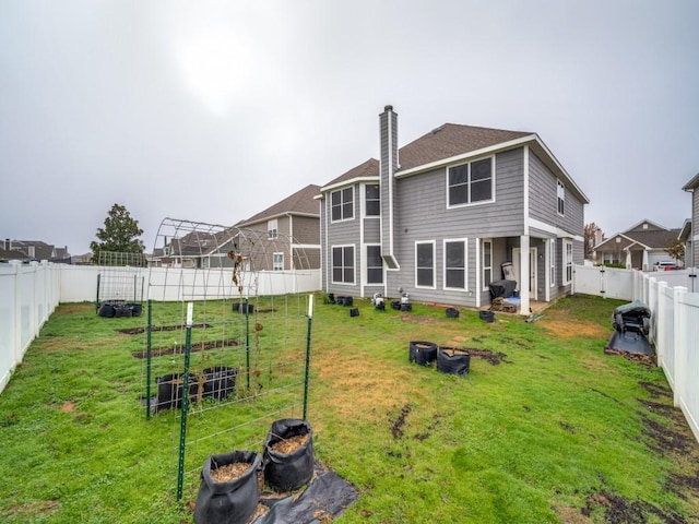 rear view of property with a yard