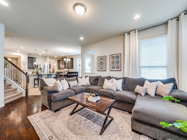 living room featuring an inviting chandelier and hardwood / wood-style flooring