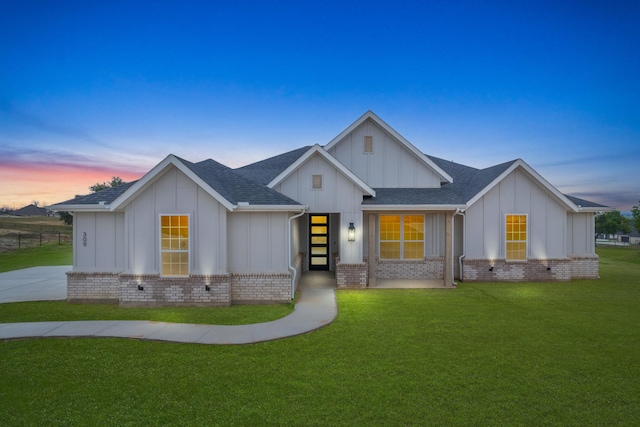 modern farmhouse style home with a lawn