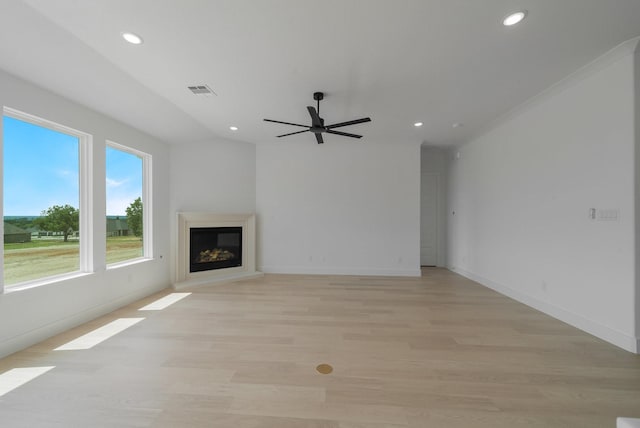 unfurnished living room featuring ceiling fan and light hardwood / wood-style flooring