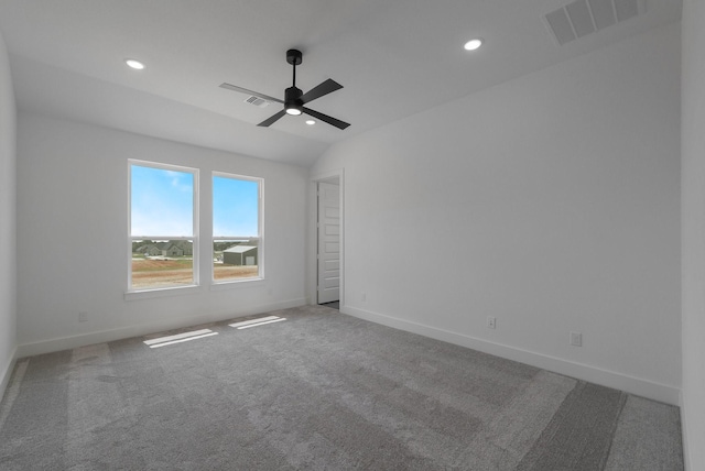 empty room featuring ceiling fan and carpet