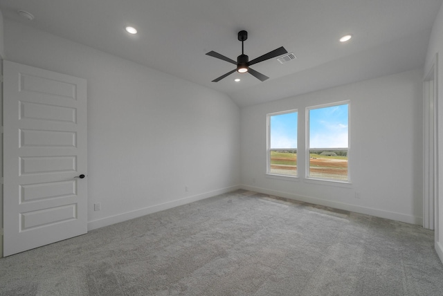 unfurnished room featuring lofted ceiling, light colored carpet, and ceiling fan