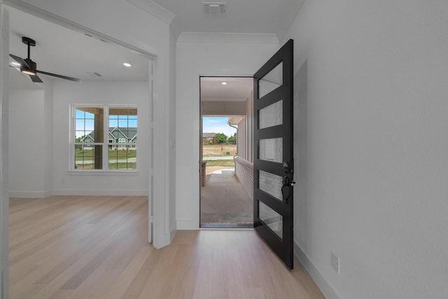 foyer entrance featuring ceiling fan, light wood-type flooring, ornamental molding, and french doors