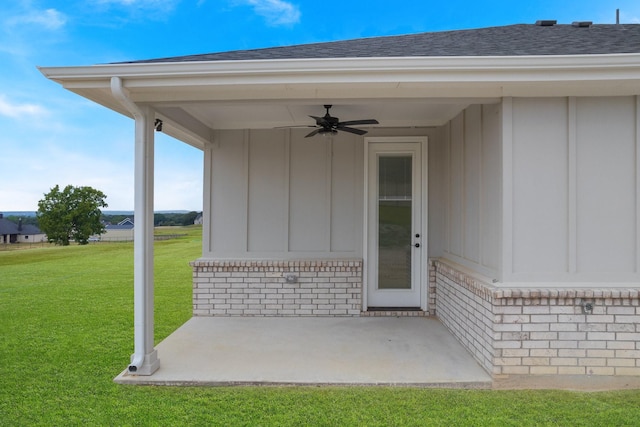 view of exterior entry with a lawn, a patio, and ceiling fan