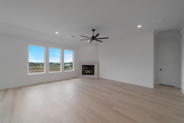 unfurnished living room featuring ceiling fan and light wood-type flooring