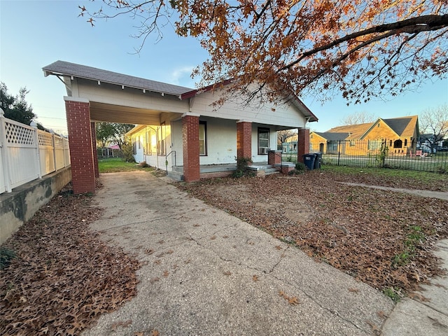 view of home's exterior featuring covered porch and a carport