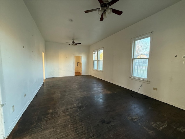 spare room featuring dark hardwood / wood-style floors and ceiling fan