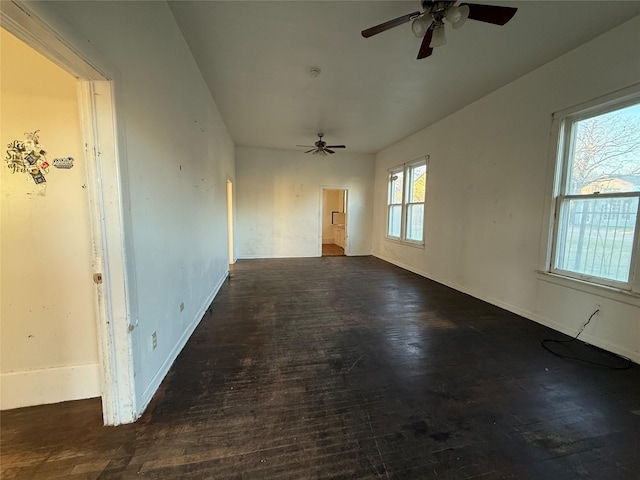 unfurnished room featuring ceiling fan and dark hardwood / wood-style flooring