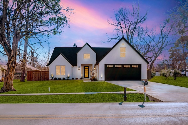 modern farmhouse style home with a garage and a lawn