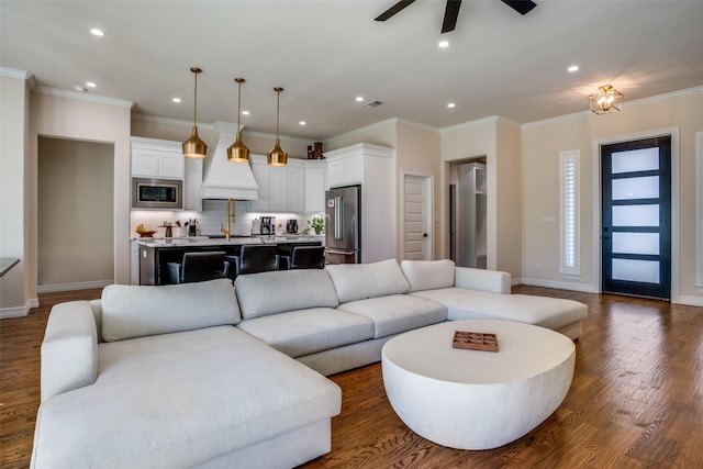 living room with ceiling fan, dark hardwood / wood-style flooring, and ornamental molding