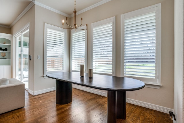 dining space featuring a wealth of natural light, dark wood-type flooring, a chandelier, and ornamental molding