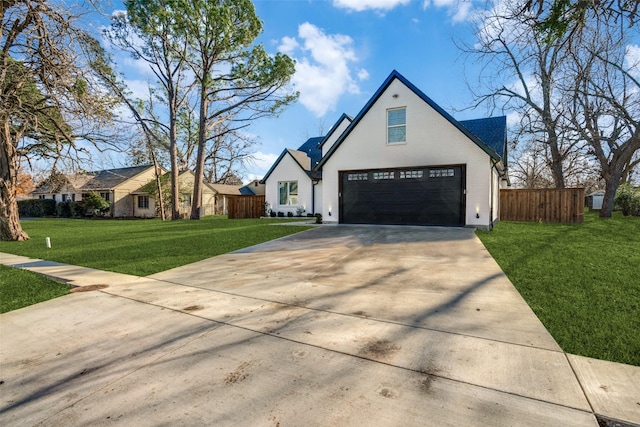 view of front of property with a front yard and a garage