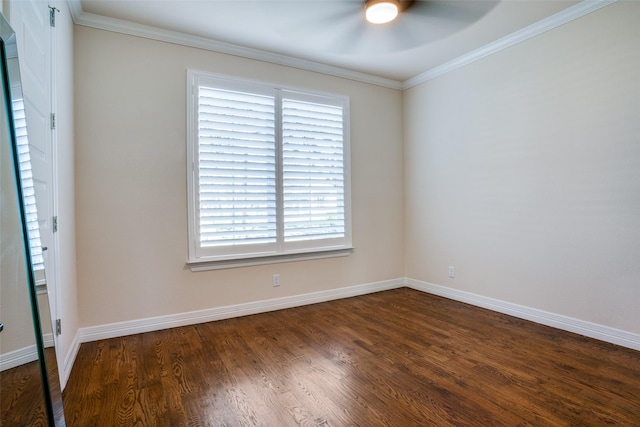 empty room with ornamental molding, dark wood-type flooring, and a wealth of natural light