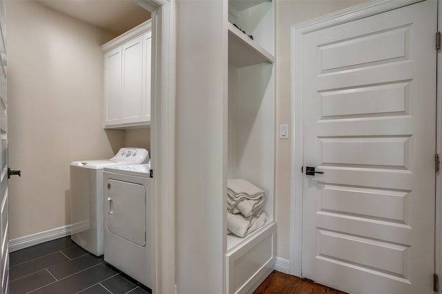 washroom with cabinets and washing machine and clothes dryer