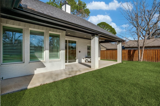 rear view of house with a patio area and a lawn