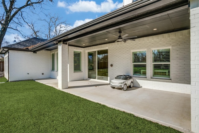 back of house with a lawn, a patio area, and ceiling fan