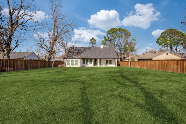 back of house featuring a yard