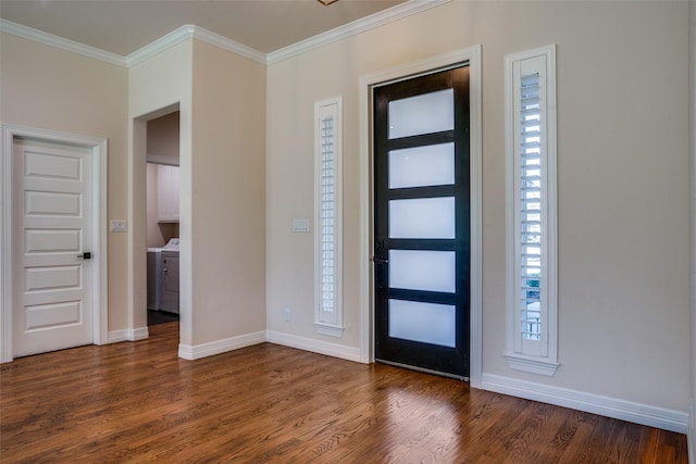 entrance foyer with washer / dryer, a healthy amount of sunlight, dark wood-type flooring, and ornamental molding