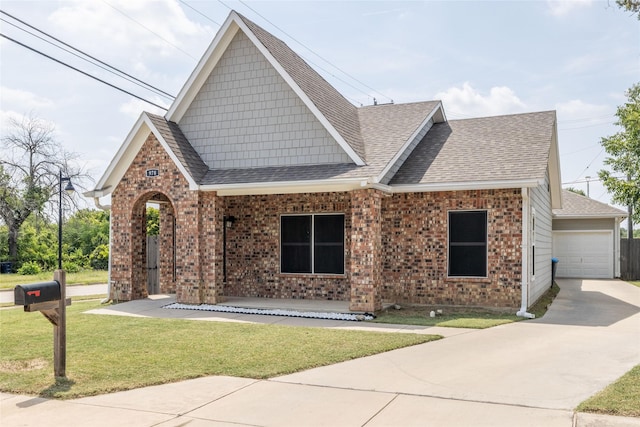 view of front of home featuring a front lawn, covered porch, and a garage