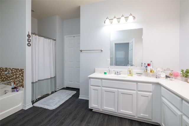 bathroom featuring vanity, hardwood / wood-style floors, and a bathtub