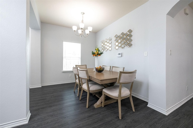 dining space with an inviting chandelier and dark hardwood / wood-style floors