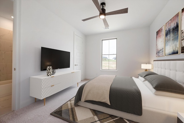 carpeted bedroom with ceiling fan and ensuite bath