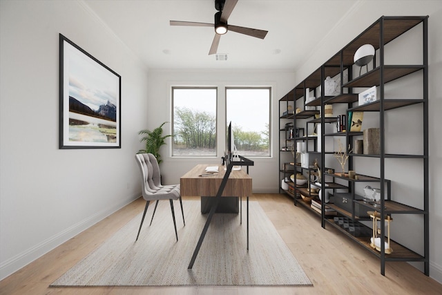 office featuring ceiling fan, ornamental molding, and light wood-type flooring