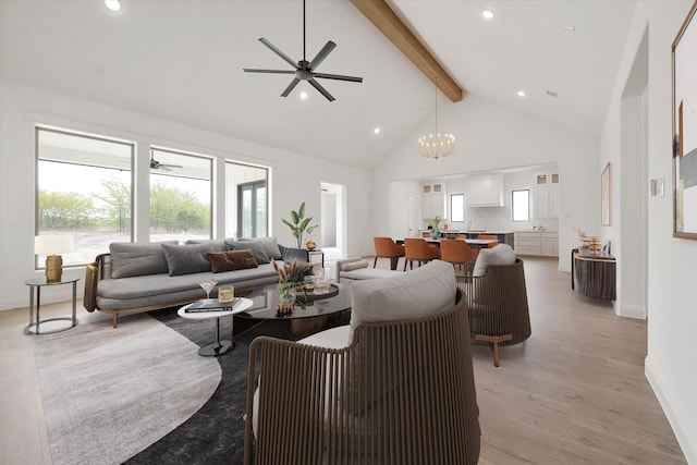 living room with beam ceiling, light hardwood / wood-style flooring, high vaulted ceiling, and ceiling fan with notable chandelier