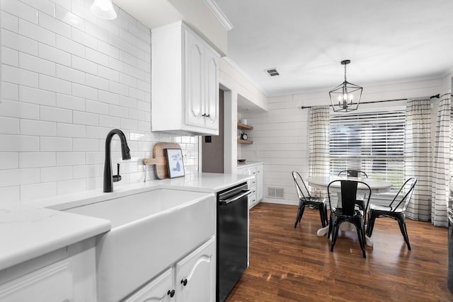 kitchen featuring dark wood-type flooring, sink, pendant lighting, dishwasher, and white cabinetry