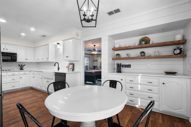 dining area featuring dark hardwood / wood-style floors and ceiling fan with notable chandelier