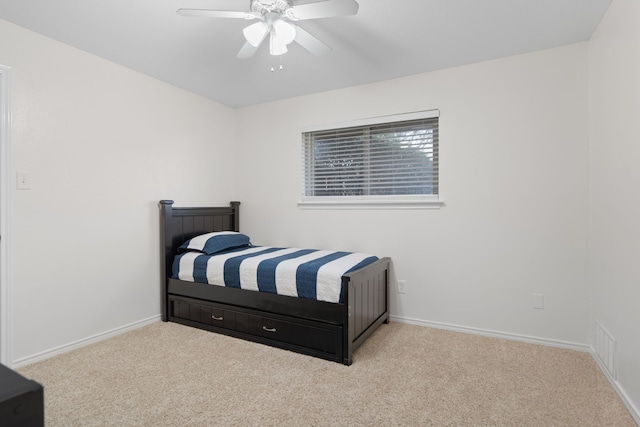 bedroom with ceiling fan and light colored carpet