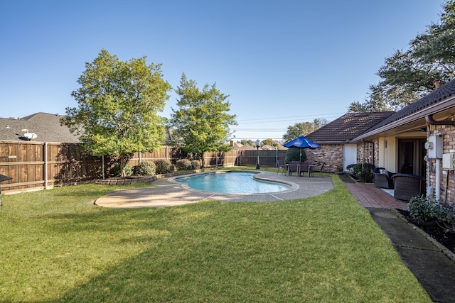 view of swimming pool with a lawn and a patio