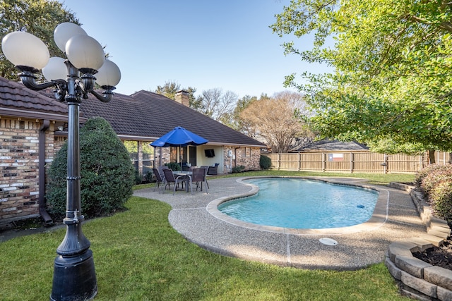 view of pool with a yard and a patio area