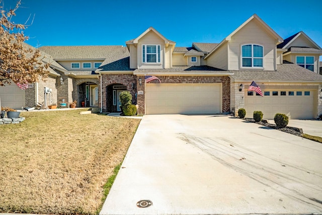 view of front of house featuring a garage and a front lawn