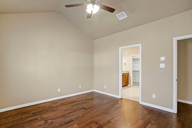 spare room featuring dark wood-type flooring, ceiling fan, and vaulted ceiling