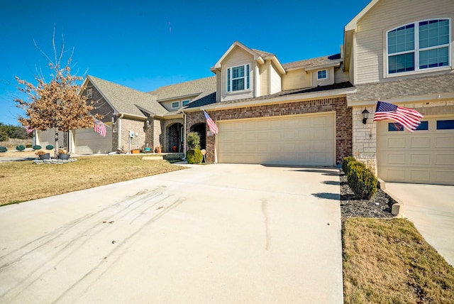 view of front of home featuring a garage and a front yard