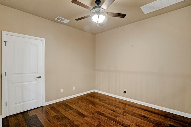 spare room featuring dark wood-type flooring and ceiling fan