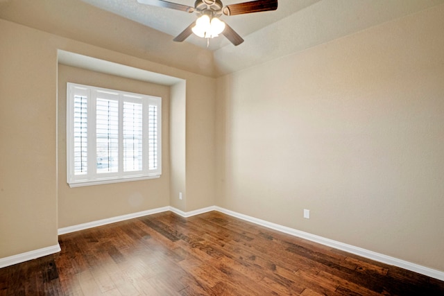 empty room with dark hardwood / wood-style flooring and ceiling fan