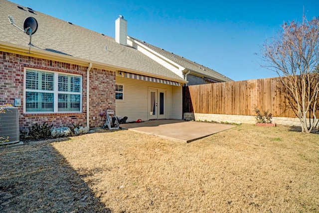 back of property featuring central AC, a yard, and a patio