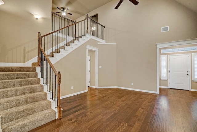 entryway with dark hardwood / wood-style flooring, high vaulted ceiling, and ceiling fan