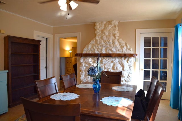 dining space featuring crown molding, light tile patterned floors, and ceiling fan