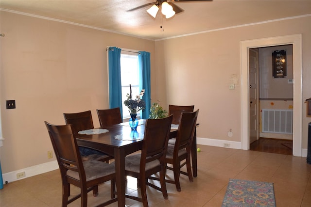 dining area featuring ceiling fan, ornamental molding, and tile patterned floors