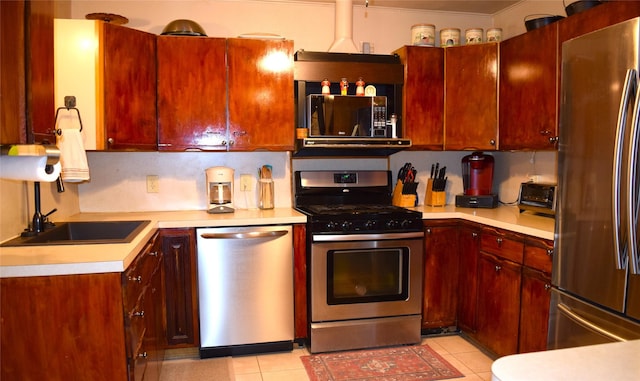 kitchen with light tile patterned floors, stainless steel appliances, and sink