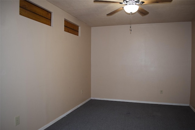 empty room with ceiling fan, carpet, and a textured ceiling