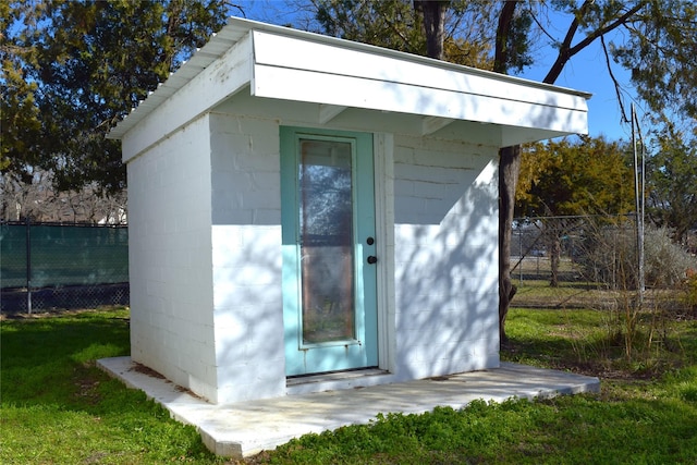 view of outbuilding with a yard