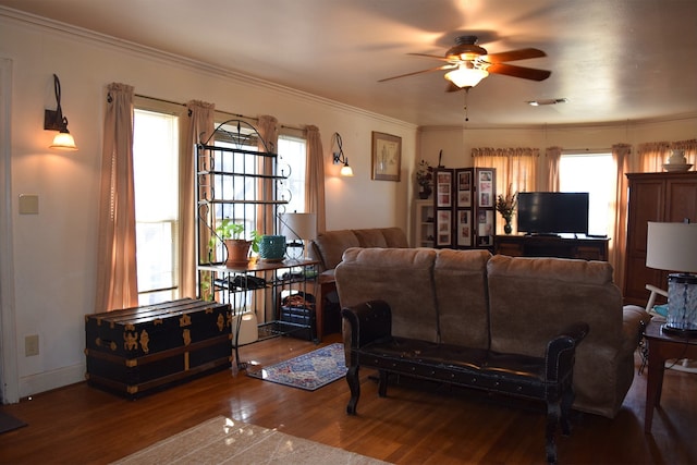 living room with a wealth of natural light, ornamental molding, hardwood / wood-style floors, and ceiling fan